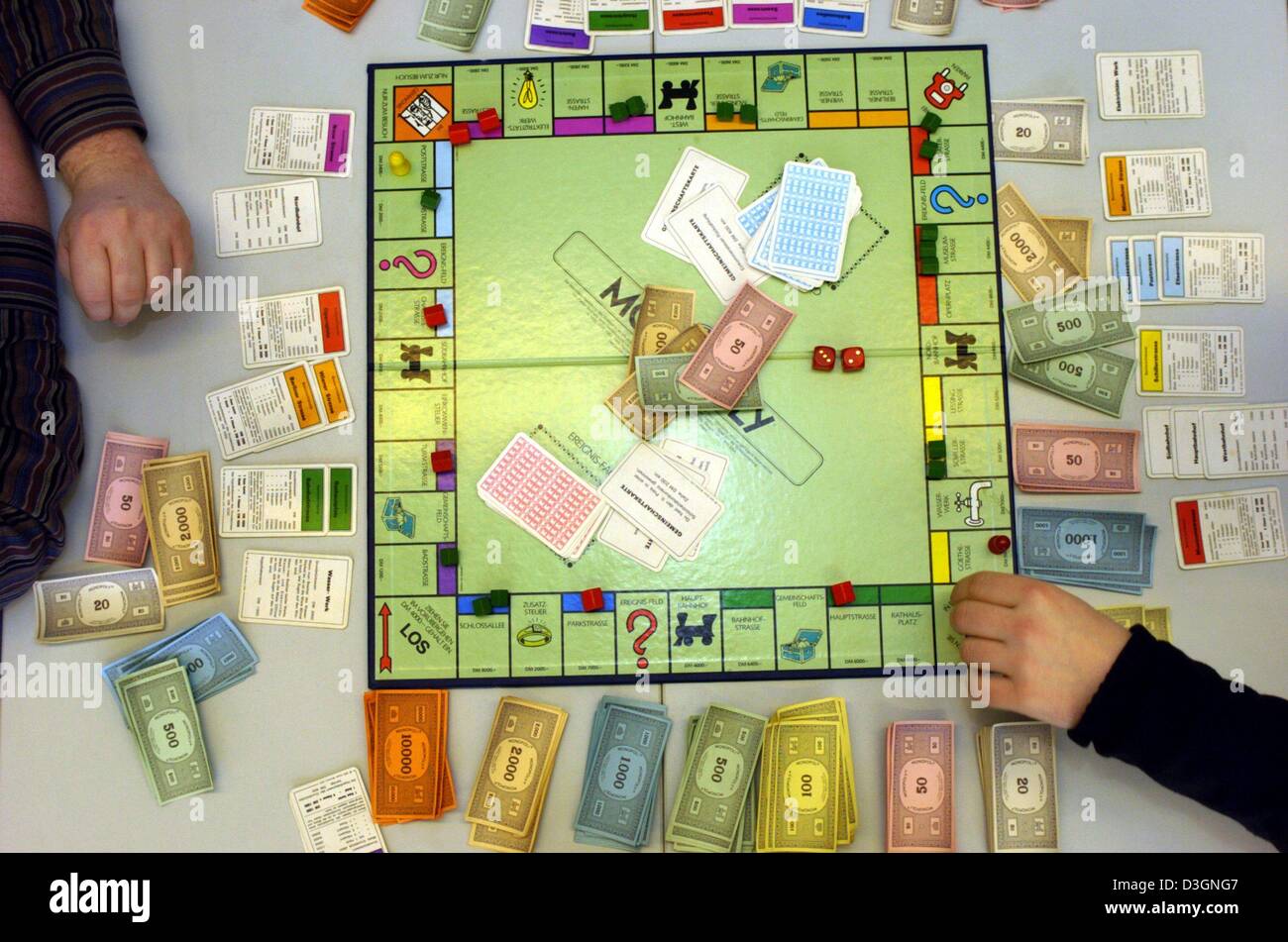 dpa) - People play the famous board game 'monopoly' in Dortmund, Germany,  10 February 2004. Monopoly is considered the world's most popular board game.  Today it is the best-selling board game in