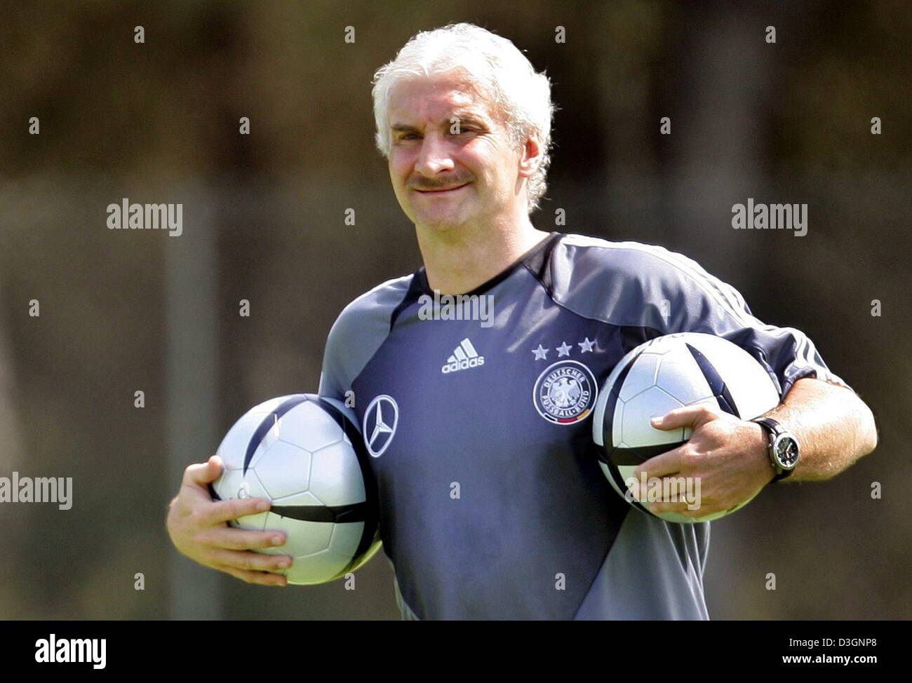 (dpa) German soccer coach Rudi Voeller smiles during a training session of the Germany team in