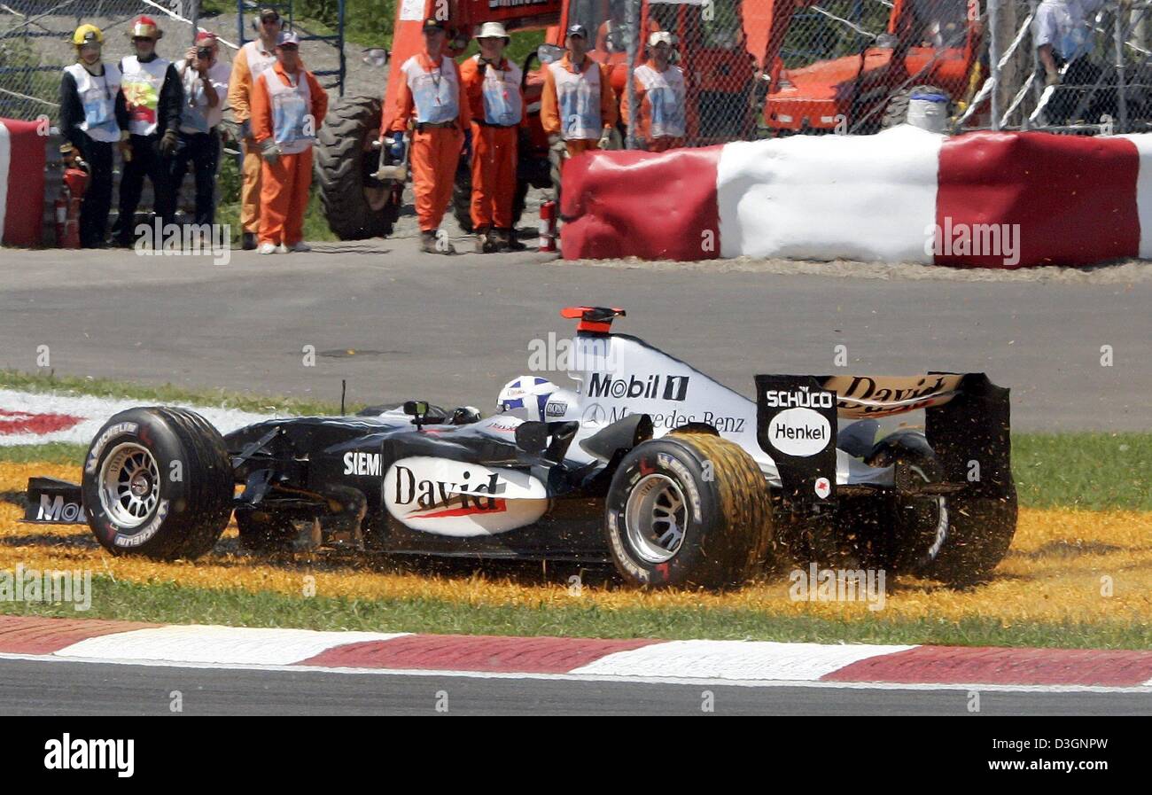 (dpa) - Scottish formula one pilot David Coulthard (McLaren Mercedes) drive his racing car across a patch of grass after a collision at the start of the Grand Prix of Canada in Montreal, Canada, 13 June 2004. Stock Photo