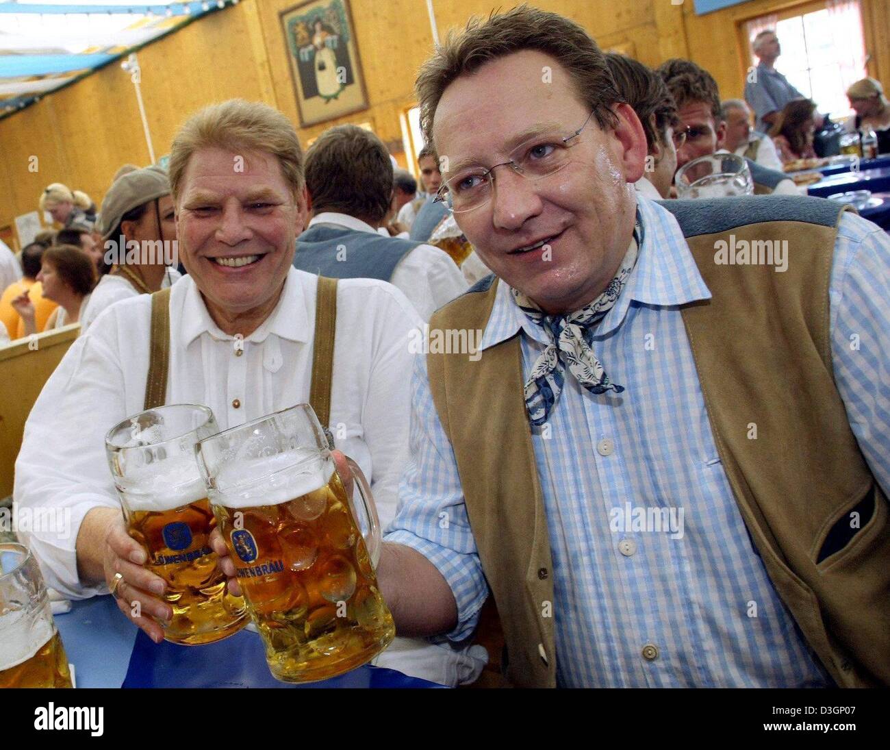 (dpa files) The president of the German premier league soccer club TSV 1860 MunichKarl-Heinz Wildmoser (left ) and his son and business manager Karl-Heinz Wildmoser junior celebrate on the Oktoberfest in Munich on 21 September 2003. Wildmoser was arrested on Tuesday, 9 March 2004, along with his son as well as two unnamed persons. An official said that they were investigating fraud Stock Photo