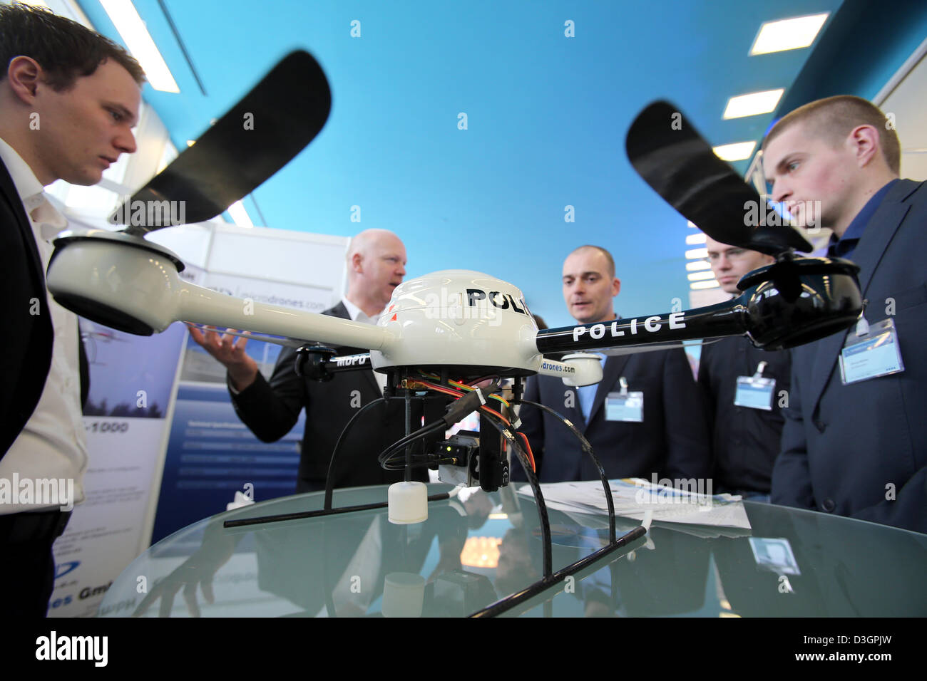 Participants learn about a micro drone of the type Typ MD 4-200 at the 16th European Police Congress in Berlin, Germany, 19 February 2013. The Congress with the motto 'Schutz und Sicherheit im digitalen Raum' ('Protection and safety in the digital space') focuses on the role of the police in social networks, ePolice and equipment and ends on 20 February 2013. Photo: Wolfgang Kumm Stock Photo