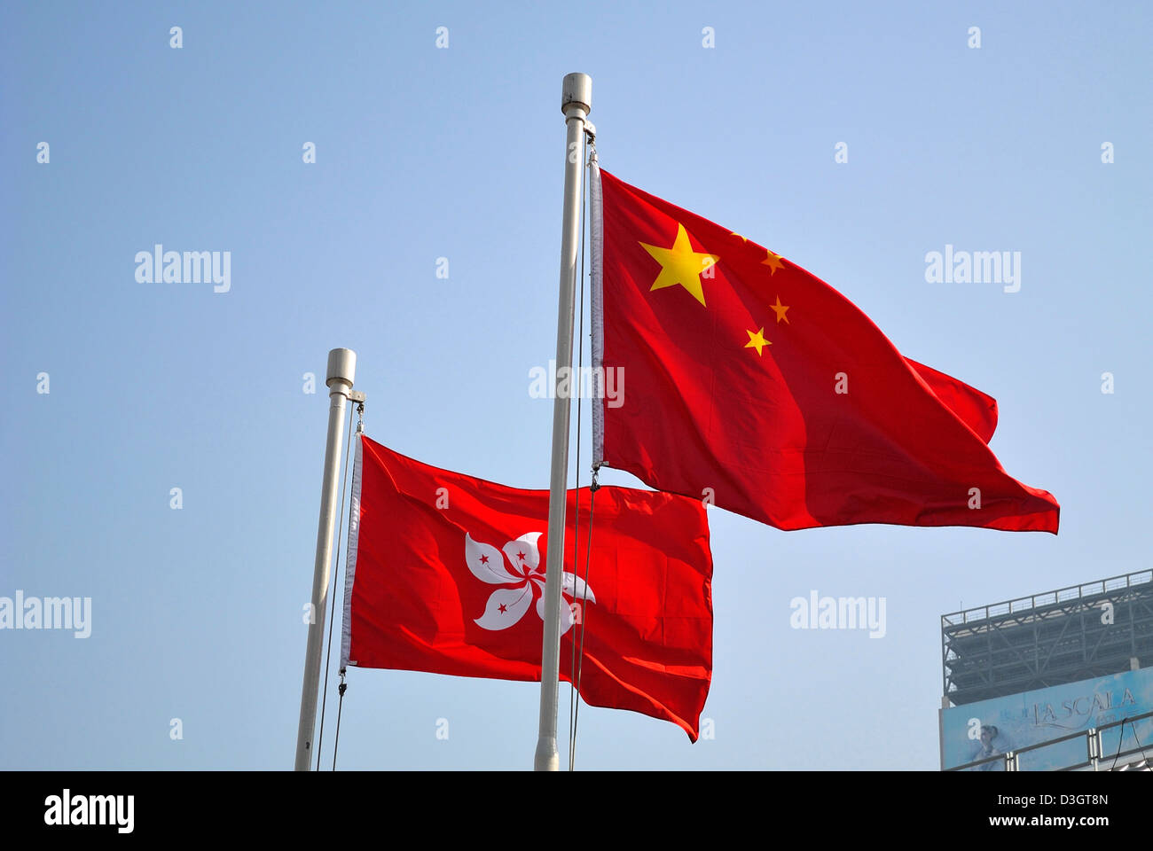 Chinese and Hongkong flags blowing in the wind Stock Photo