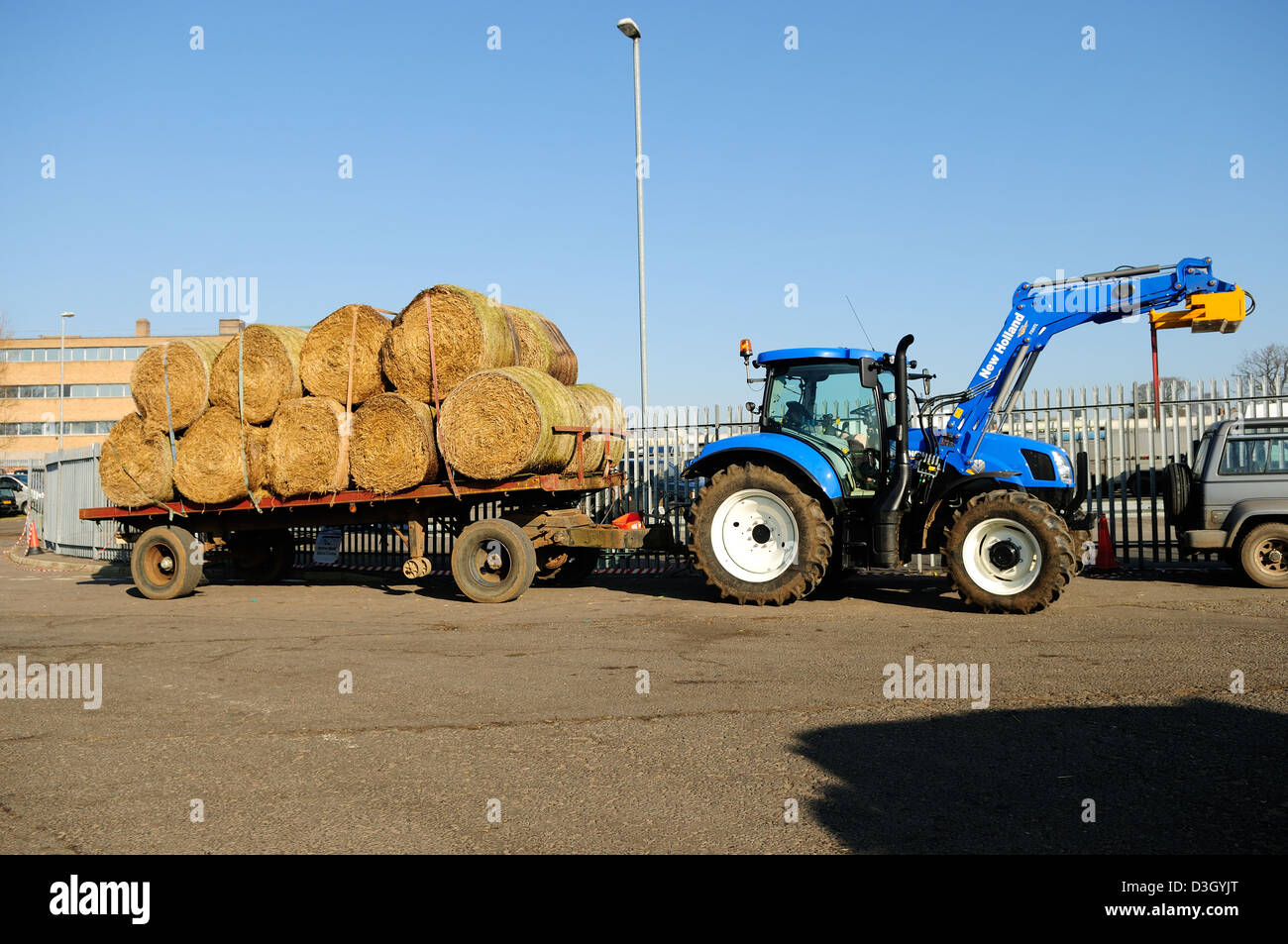 New Holland Tractor and Trailer with Hay Load. Stock Photo