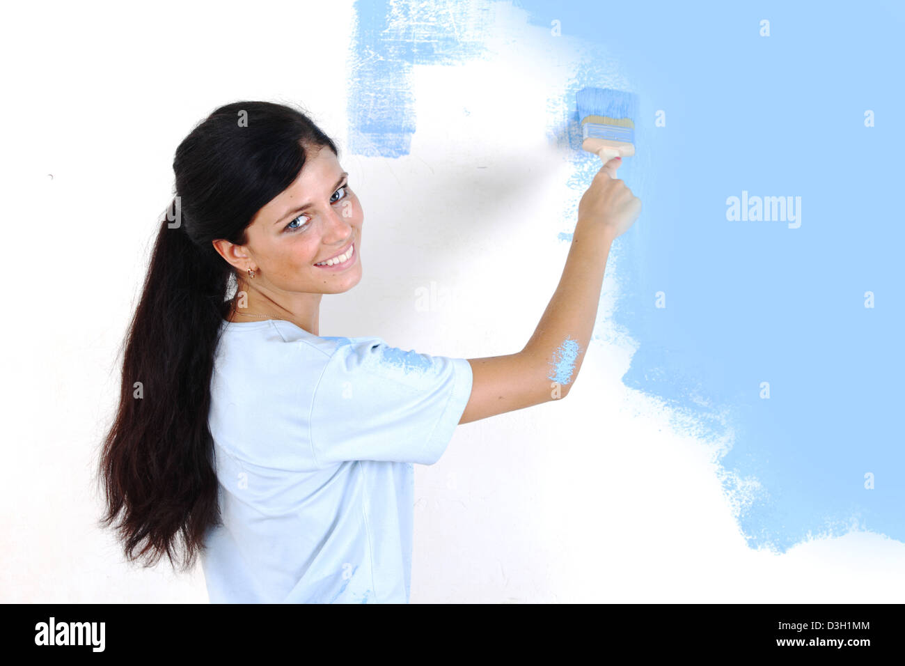woman paints the wall brush Stock Photo Alamy