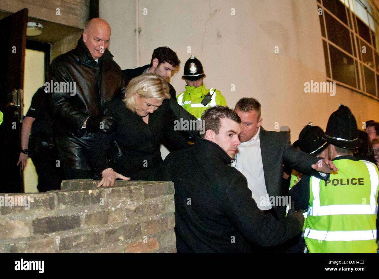 Cambridge, UK. 19th February 2013. Marine Le Pen is bundled out of a side entrance of the Cambridge Union to a waiting police van after delivering a speech. Credit:  martyn wheatley / Alamy Live News Stock Photo