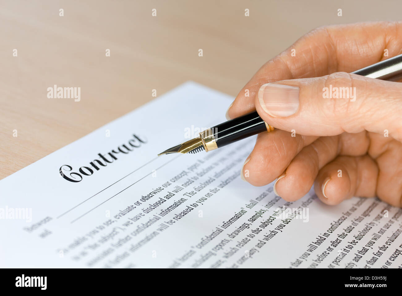 Hand with Fountain Pen Signing a Contract Stock Photo