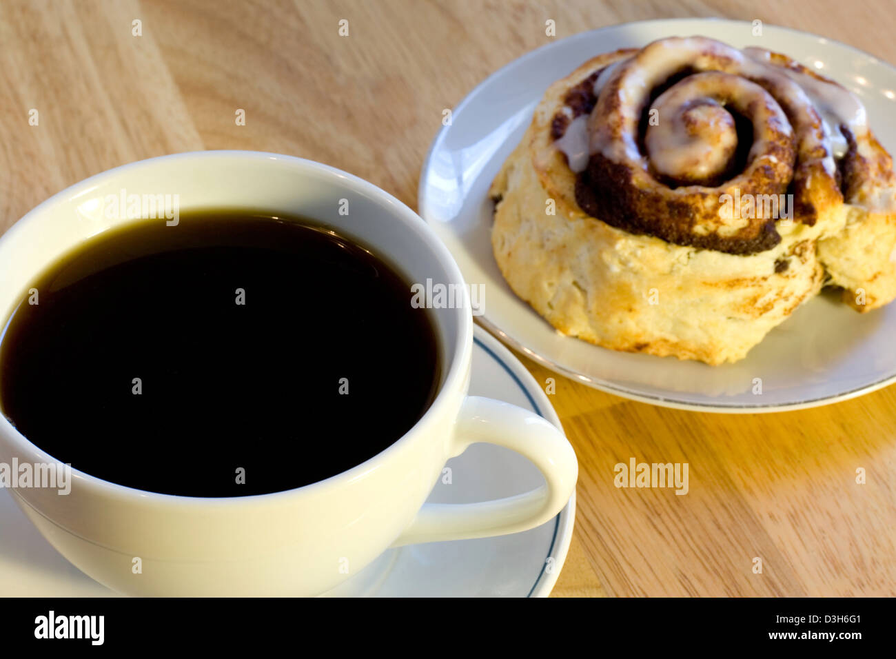 Fresh Black Coffee And A Cinnamon Roll Focus On The Coffee Stock Photo Alamy Fresh Black Coffee And A Cinnamon Roll Focus On The Coffee Stock Photo Alamy
