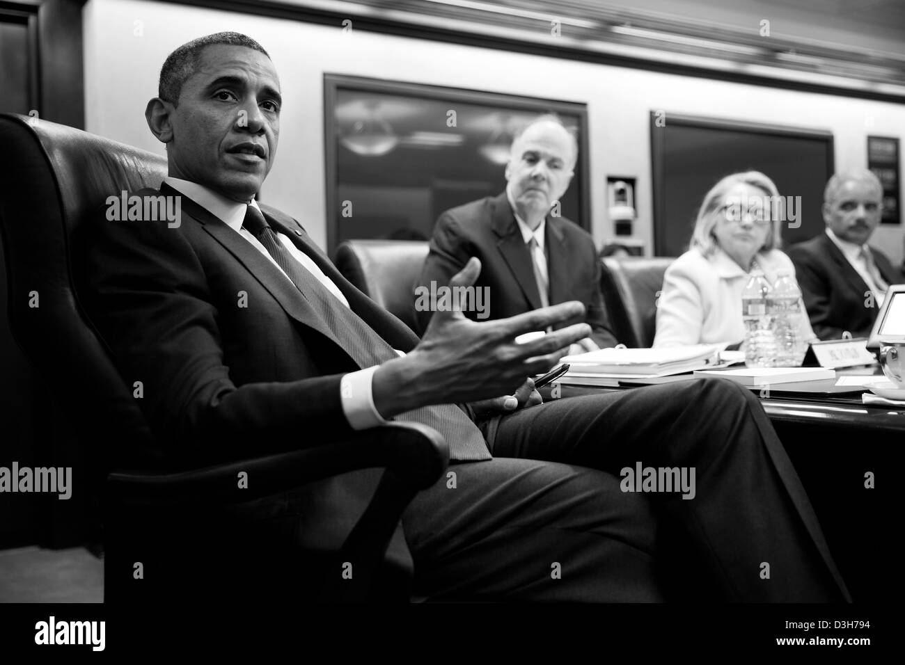 US President Barack Obama and Vice President Joe Biden hold a meeting in the Situation Room of the White House January 24, 2013 in Washington, DC. Seated, from left, are: National Security Advisor Tom Donilon, Secretary of State Hillary Rodham Clinton, and Attorney General Eric Holder. Stock Photo