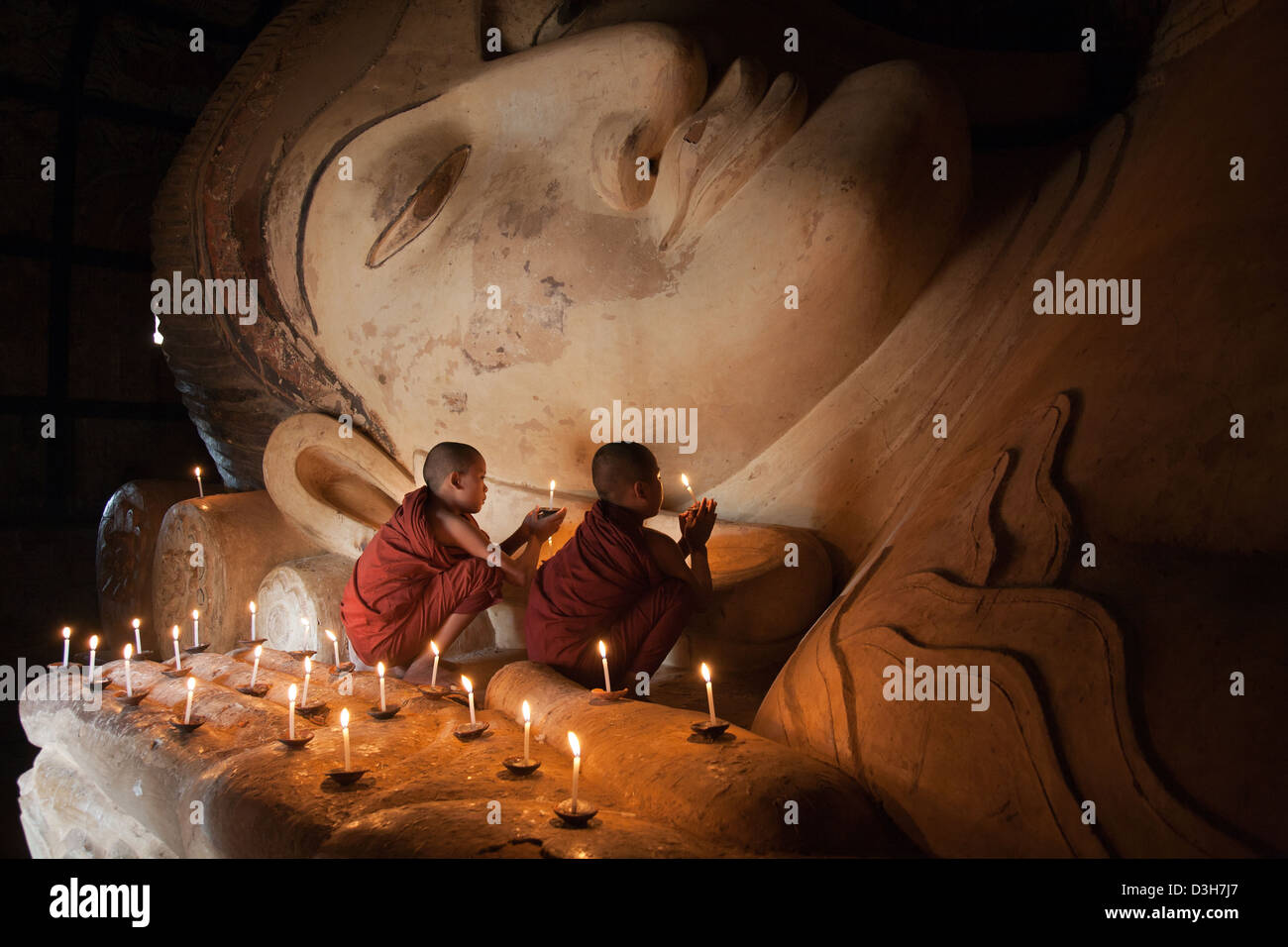 Two young monks meditating at The sleeping Buddha, Shwesandaw Paya Bagan Stock Photo