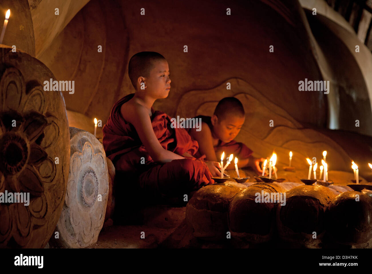 Two young monks meditating at The sleeping Buddha, Shwesandaw Paya Bagan Stock Photo