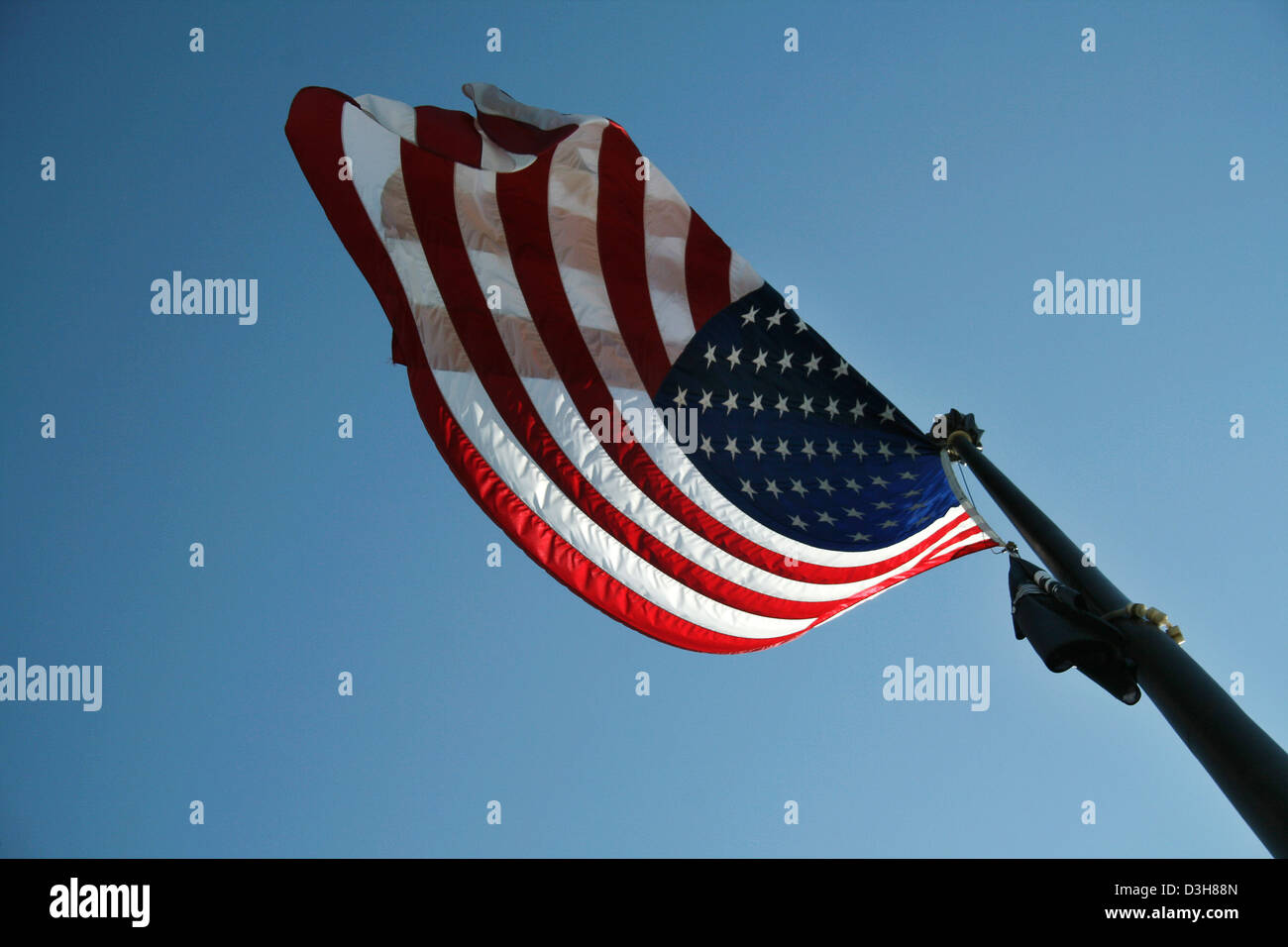 American flags flying with blue sky background Stock Photo - Alamy