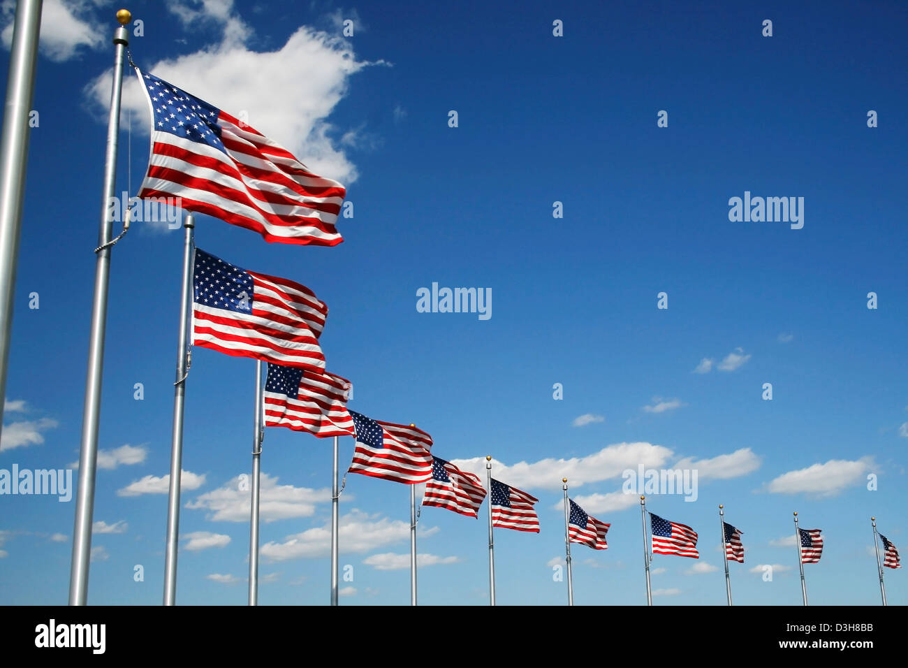 American flags flying with blue sky background Stock Photo - Alamy