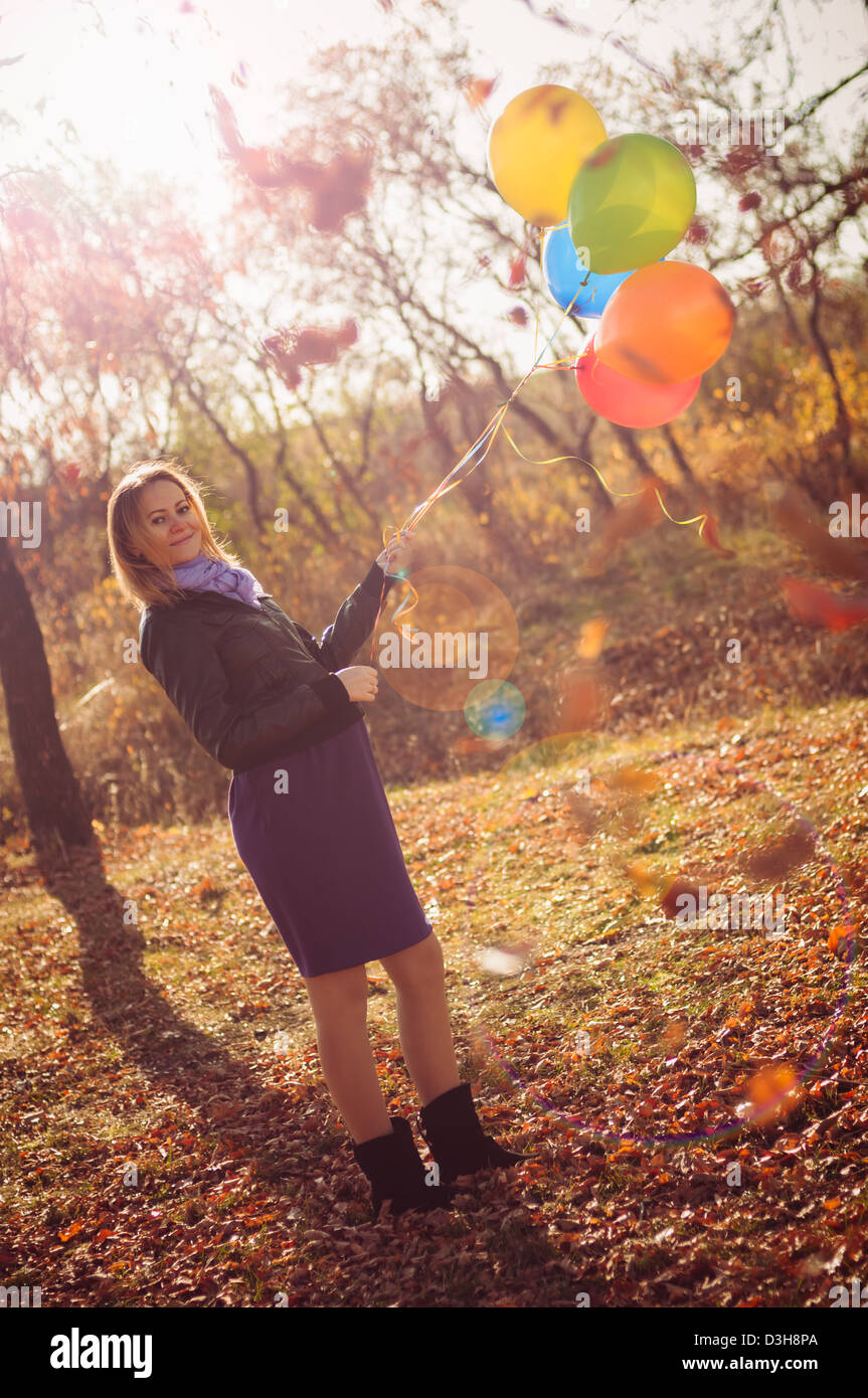 Young pregnant woman with colorful balloons in autumn forest Stock ...