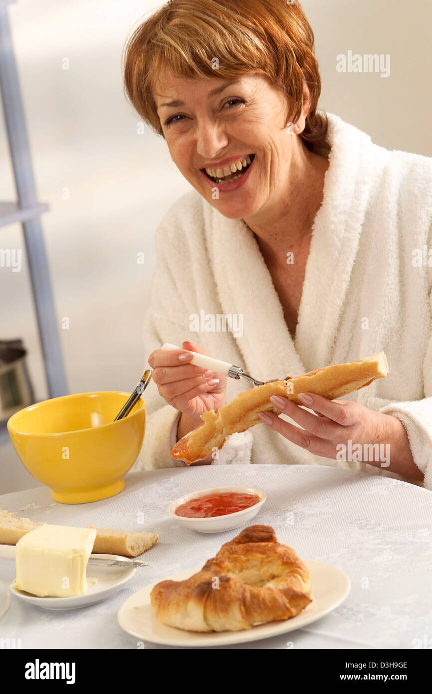 ELDERLY PERSON EATING BREAKFAST Stock Photo