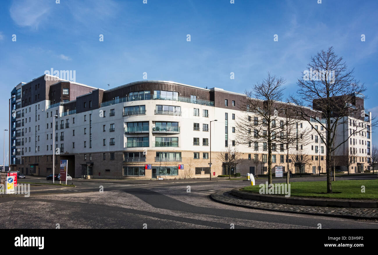 Housing complex with flats on Lower Granton Road A901 in Granton Harbour Edinburgh Scotland with Lochinvar Drive left Stock Photo
