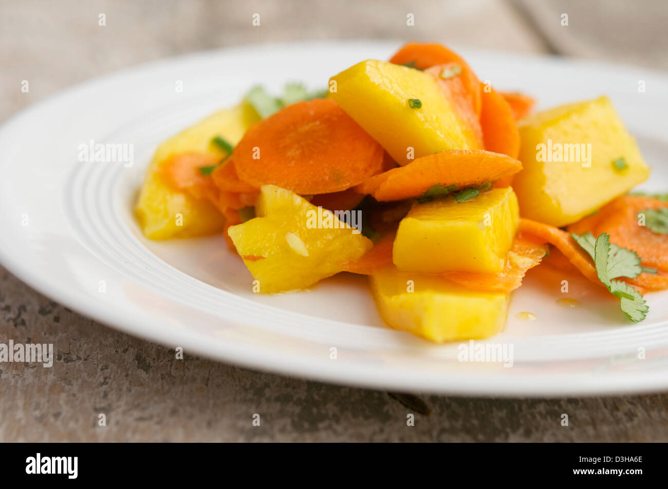 Plate with a fresh carrot and mango salad. Stock Photo