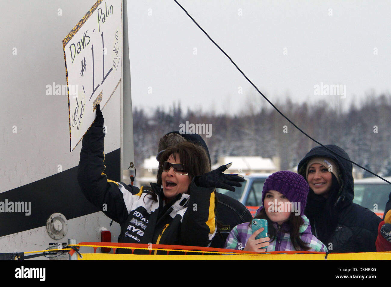 Former Alaska Governor and 2008 Vice President candidate SARAH PALIN and her daughters Piper, and Willow, right cheers  her husband and father Todd Palin as he and  he his team mate Scott Davis take off on the 2,000-mile snowm achine  race from Big Lake to Nome to Fairbanks in the Iron Dog snow machine race Stock Photo