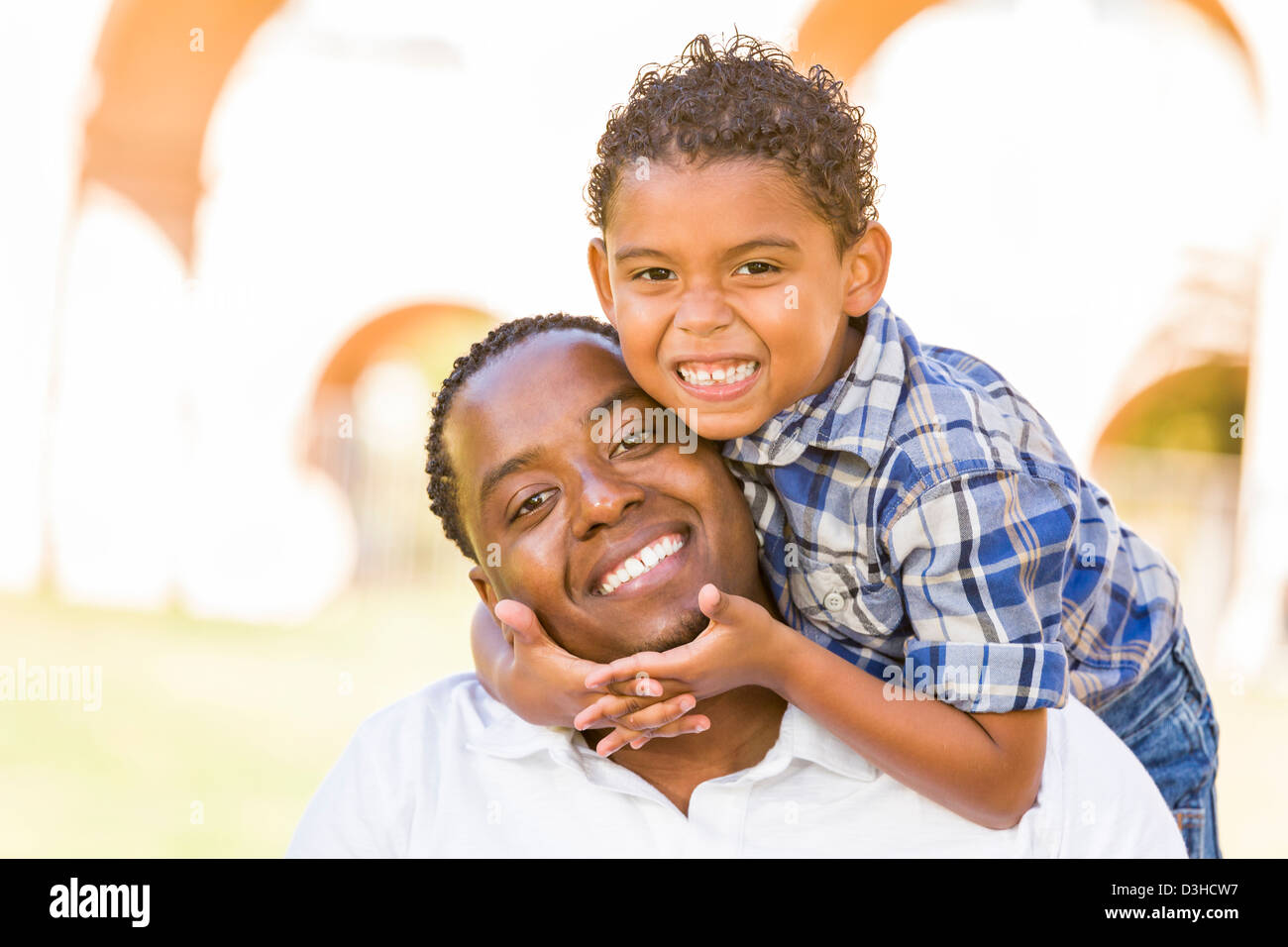 Happy African American Father and Mixed Race Son Playing Piggyback in ...