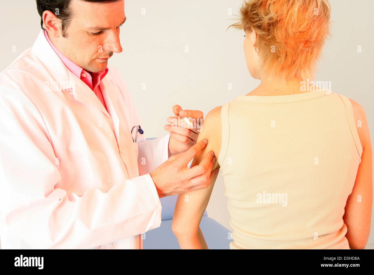 VACCINATING A WOMAN Stock Photo - Alamy