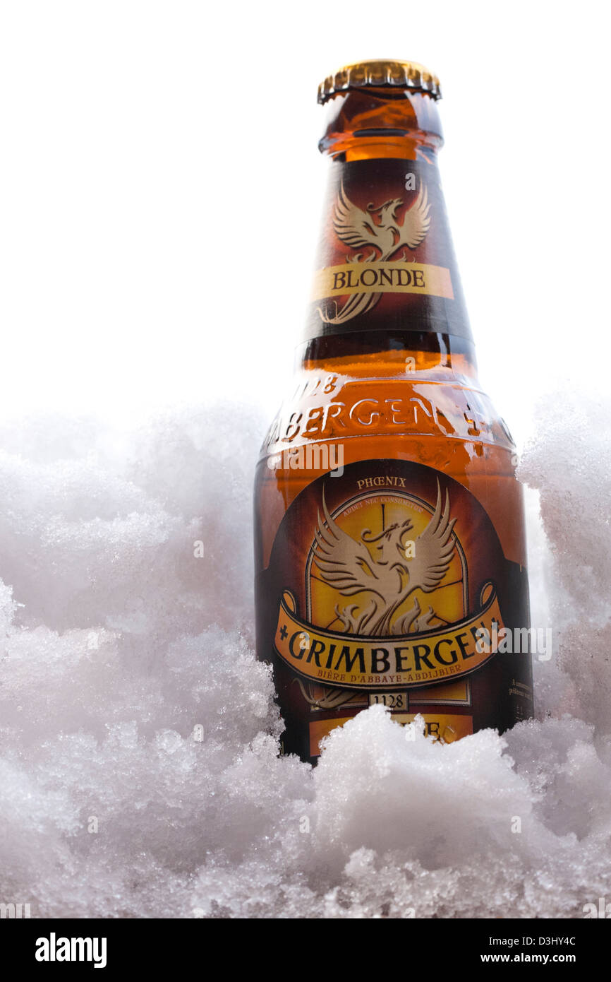 Unopened Grimbergen Blonde Beer Bottle in snow Stock Photo