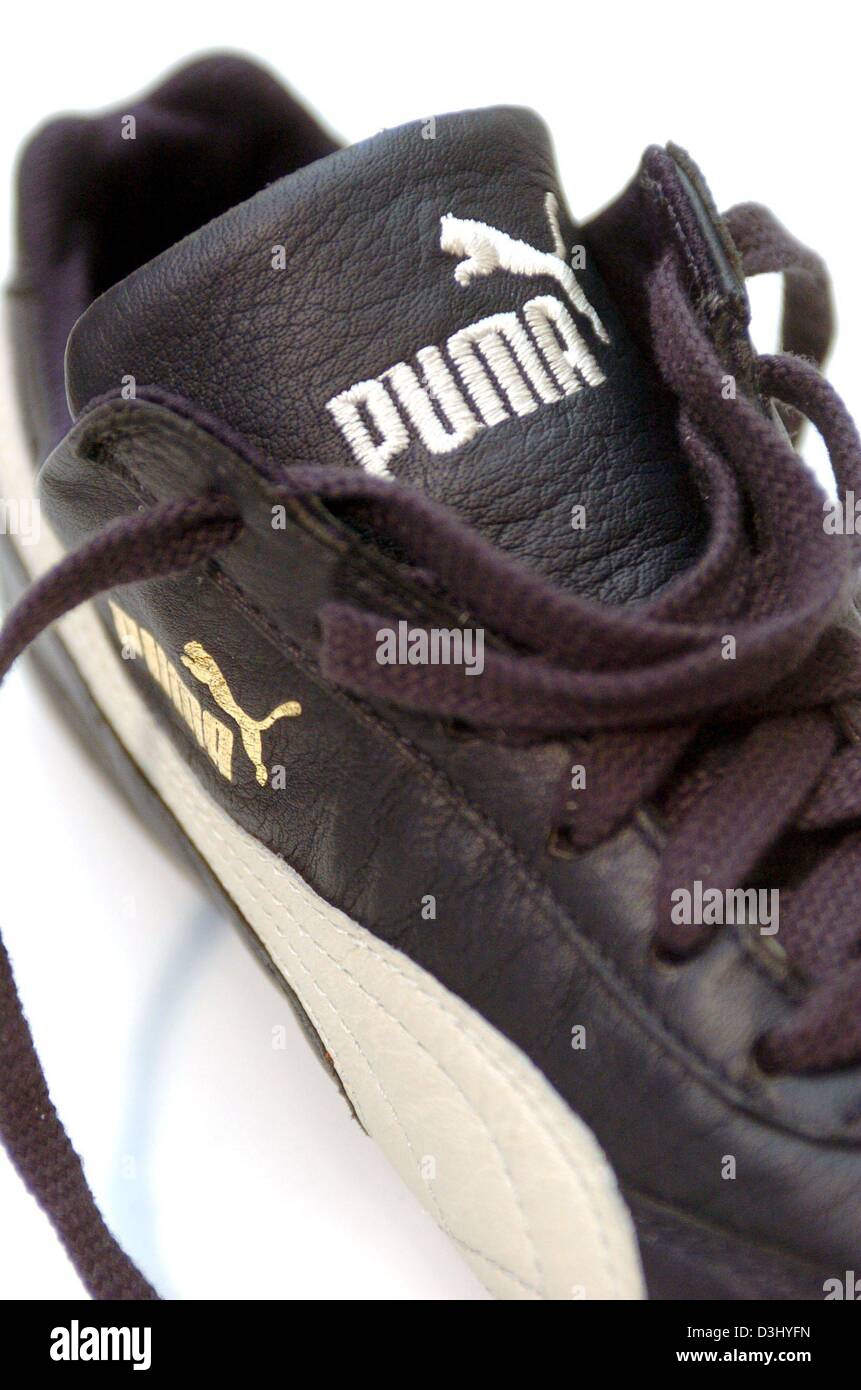 dpa files) A Puma sneaker lies on table at the Puma outlet centre in  Herzogenaurach on