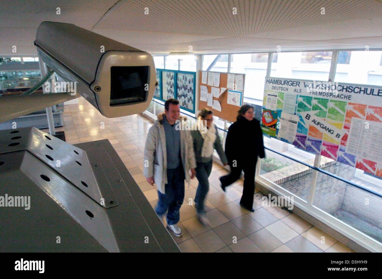 (dpa) - A security monitoring camera surveillances the entrance of a ...