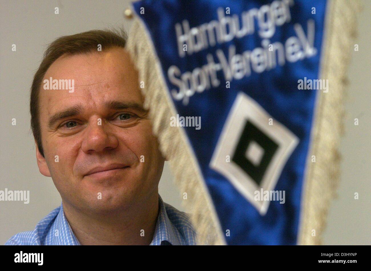 (dpa) - Bernd Hoffmann, CEO of the sports club Hamburger Sportverein (HSV), is seen behind a tennant of the club in his office at the AOL arena in Hamburg, 23 January 2004. With 41 year he is the youngest head of a German Bundesliga soccer club and celebrates his first anniversary in office in February. Stock Photo