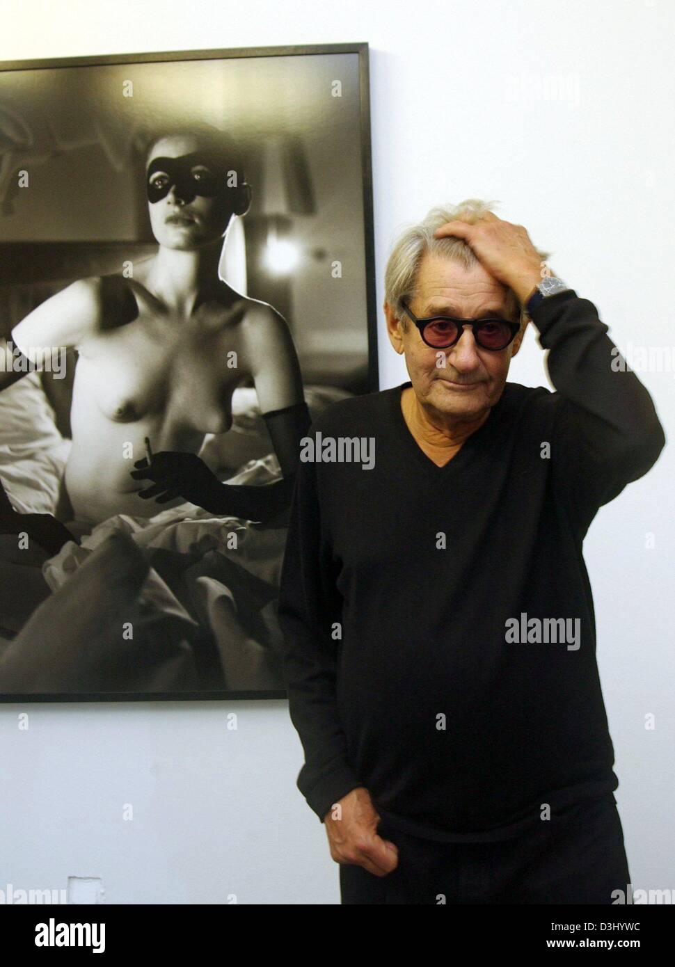 (dpa files) - Star photographer Helmut Newton stands in front of one of his photographs in an exhibition hall in Duesseldrof, Germany, 22 October 2002. 83-year-old Newton died after losing control of his car when leaving the car park at a hotel in Los Angeles on 23 January 2004, police said. Friends presume a possible heart attack.  Newton was a world famous art photographer who sp Stock Photo
