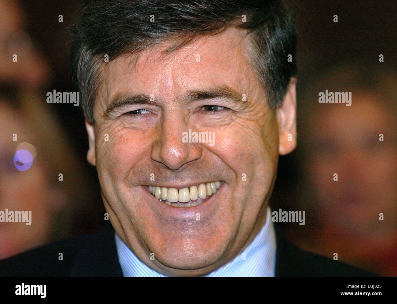 (dpa) - Josef Ackermann (R), chairman of the Deutschen Bank AG, smiles shortly before the start of the so-called Mannesmann trial at the District Court in Duesseldorf, Germany on Wednesday, 21 January 2004. The trial focuses on the controversial severance payments which were payed during the purchase of Mannesmann by the British telecommunications group Vodafone. The public prosecu Stock Photo