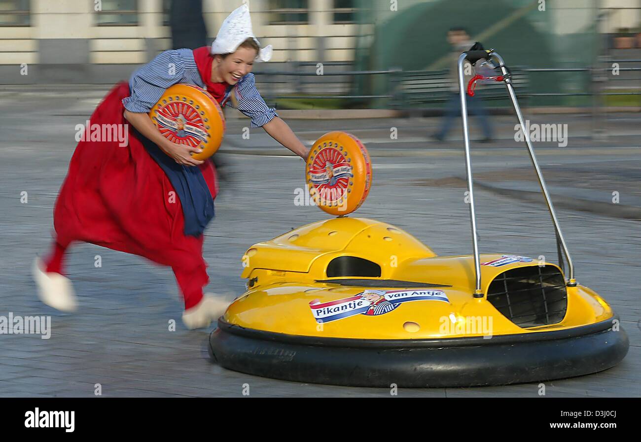 (dpa) - With cheese on her arms, Madeleen, the 'flying Dutchwoman', runs after a floating cheese board in Berlin, 15 January 2004. The cheesy 'airboard' works like a hovercraft and was designed for a promotion of Dutch dairy products at the Green Week fair in Berlin. The world's biggest agricultural fair is open to the public from 16 to 25 January 2004. Stock Photo