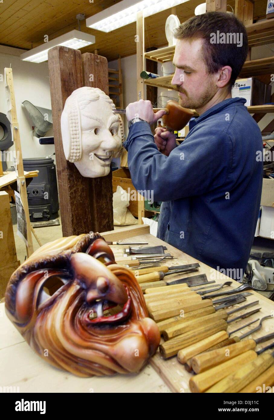 (dpa) - Carver Bernhard Ehmer works on a wooden carnival mask in his workshop in Herxheim, Germany, 2 February 2004. The wooden masks are a tradition of the Alemannic carnival in southwestern Germany. Stock Photo