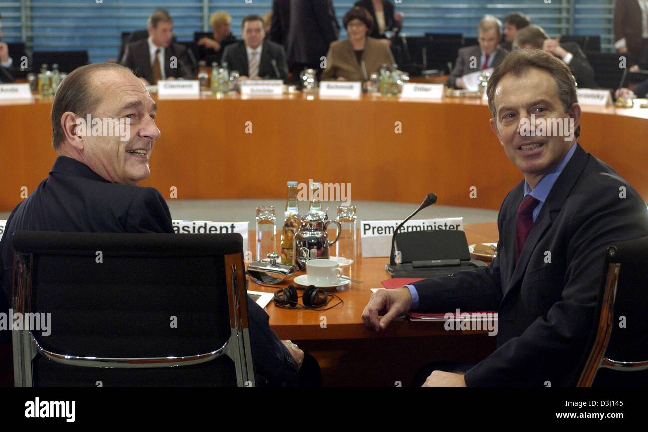 (dpa) - French President Jacques Chirac (L) and British Prime Minister Tony Blair (R) sit at the conference table during the EU 'Big Three' summit in Berlin, 18 February 2004. Apart from discussing future moves in the European Union, the three heads of state from Germany, France and Britain hope to lay aside divisions caused by the Iraq war and to talk up Europe's fragile economy.  Stock Photo