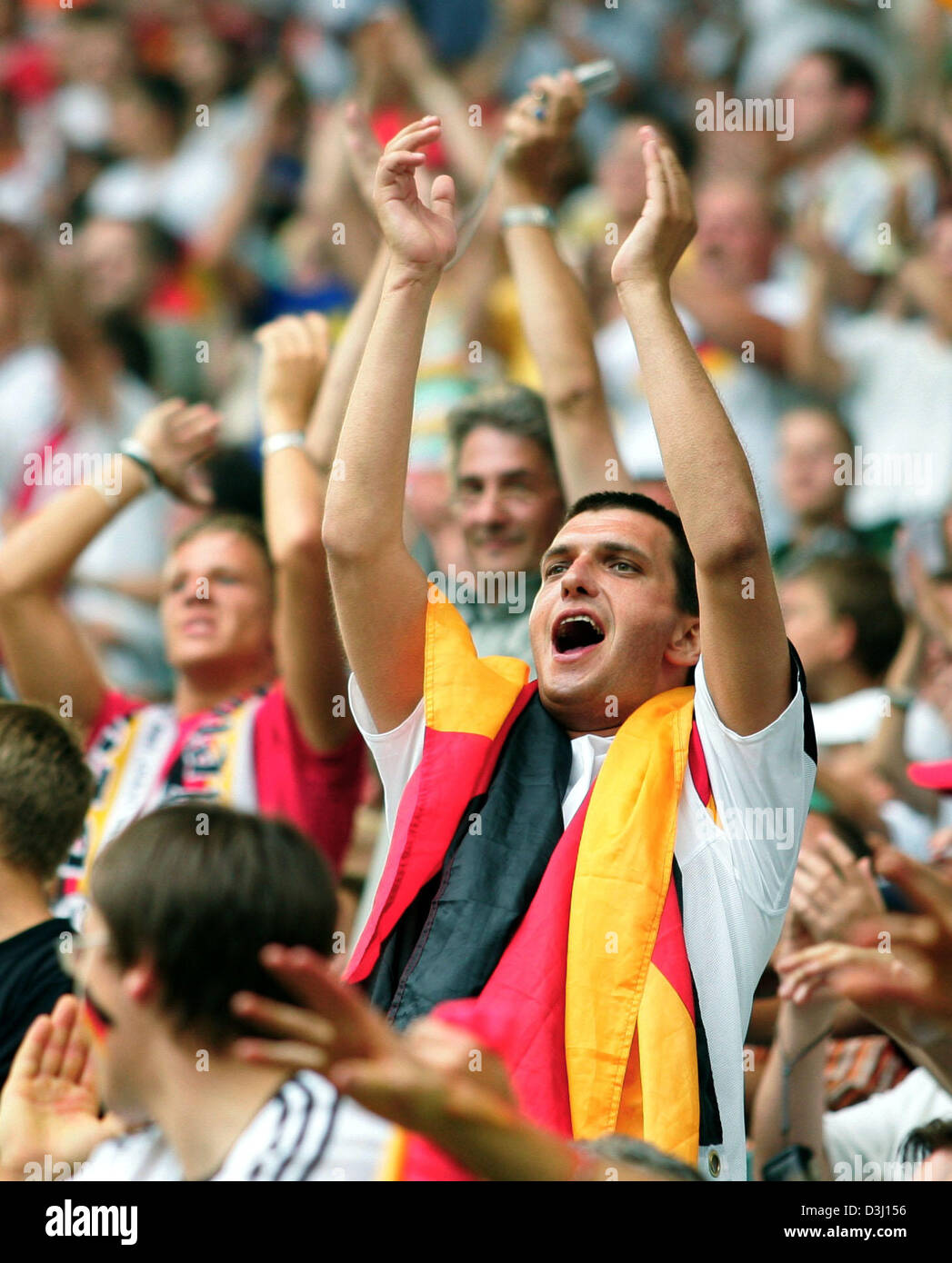 (dpa) German soccer fans cheer and celebrate during the third place