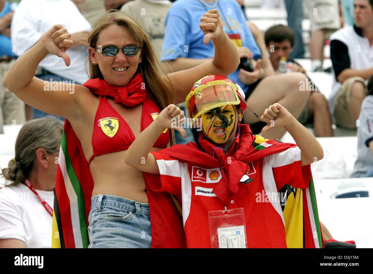 dpa) - The picture shows Formula One fans protesting with thumbs
