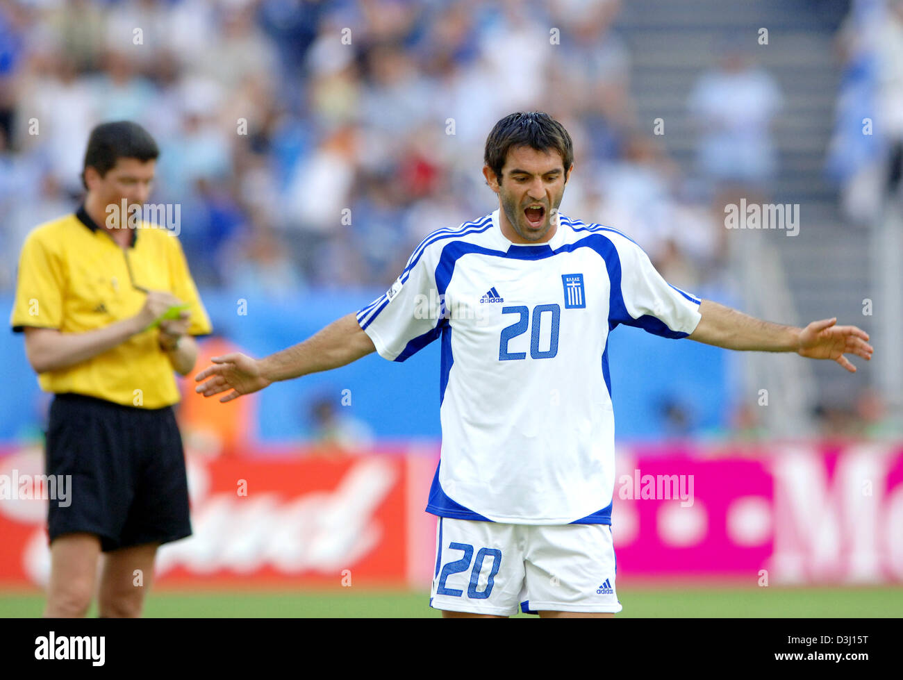 (dpa) - Greek soccer player Georgios Karagounis (R) acts angry after receiving a yellow card from German referee Herbert Fandel during the group B match of the Confederations Cup tournament Greece vs Japan in Frankfurt, Germany, 19 June  2005. (Editorial note: Internet use and mobile applications subject to FIFA's terms and conditions) Stock Photo
