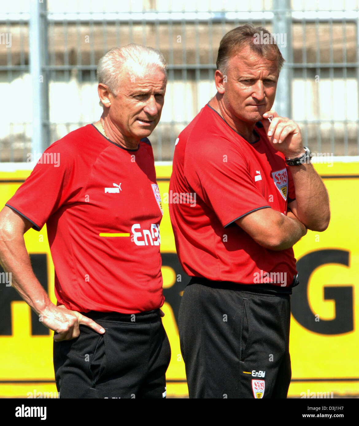 (dpa) - Head Coach of German Bundesliga club VfB Stuttgart Italian Giovanni Trapattoni (L) watches the players train in Stuttgart, Germany, 27 June 2005. Besides Trappatoni stands Assistant Coach German soccer legend Andreas Brehme. Stock Photo
