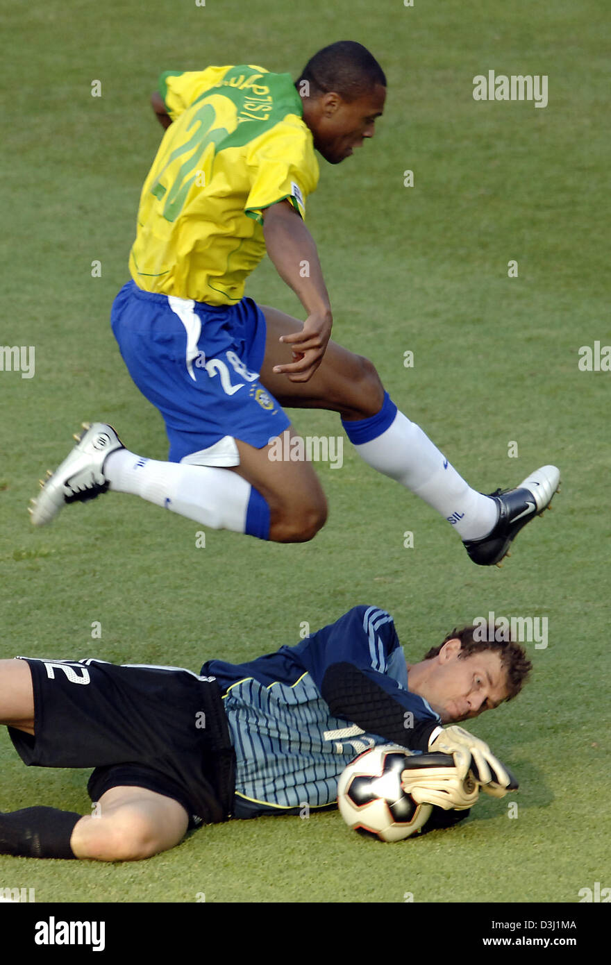 (dpa) - German goalkeeper Jens Lehmann grabs the ball in front of Brazilian Julio Baptista during the semi-final of the FIFA Confederations Cup tournament Germany vs. Brazil in Nuremberg, Germany, 25 June 2005. Stock Photo
