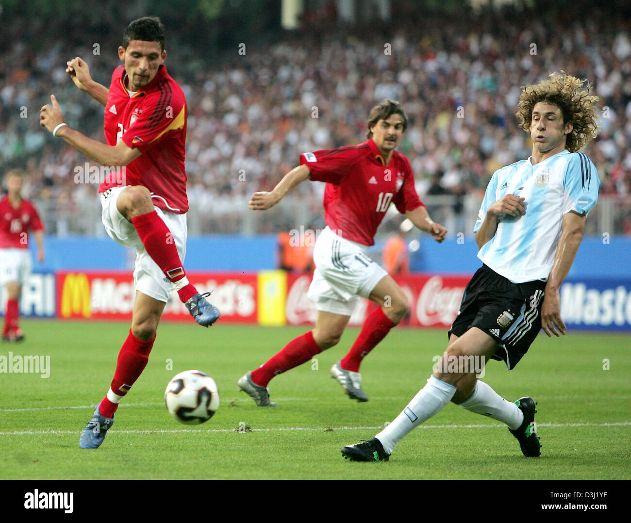 (dpa) - German soccer player Kevin Kuranyi (L) tries to score despite the presence of Argentinian defender Fabricio Coloccini (R) during their match at the FIFA Confederations Cup 2005 at the Franken-Stadium in Nuremberg, Germany, 21 June 2005. In the back watches German Sebastian Deisler (C) the situation. The match ended in a 2-2 draw. Stock Photo