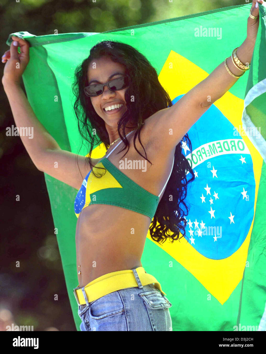 (dpa) - Rosi from Brazil smiles and poses with the Brazilian national flag prior to the Confederations Cup match between Brazil and Mexico in Hanover, Germany, Sunday, 19 June 2005. Stock Photo