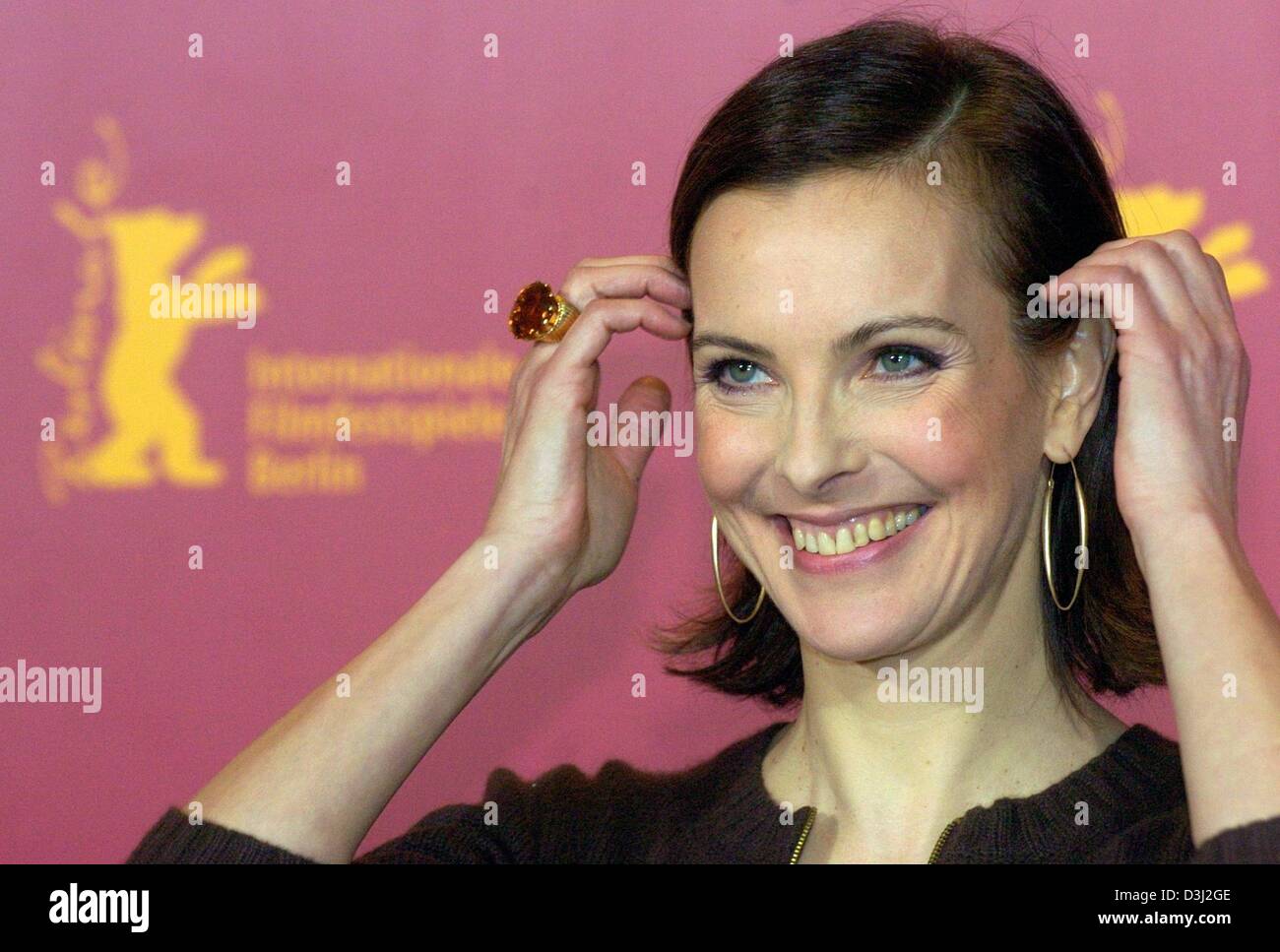 (dpa) - French actress Carole Bouquet smiles as he attends  a press conference at the 54th Berlinale International Film Festival in Berlin, 10 February 2004.  Bouquet  presented her new film 'Feux rouges' (Rear Lights). Stock Photo