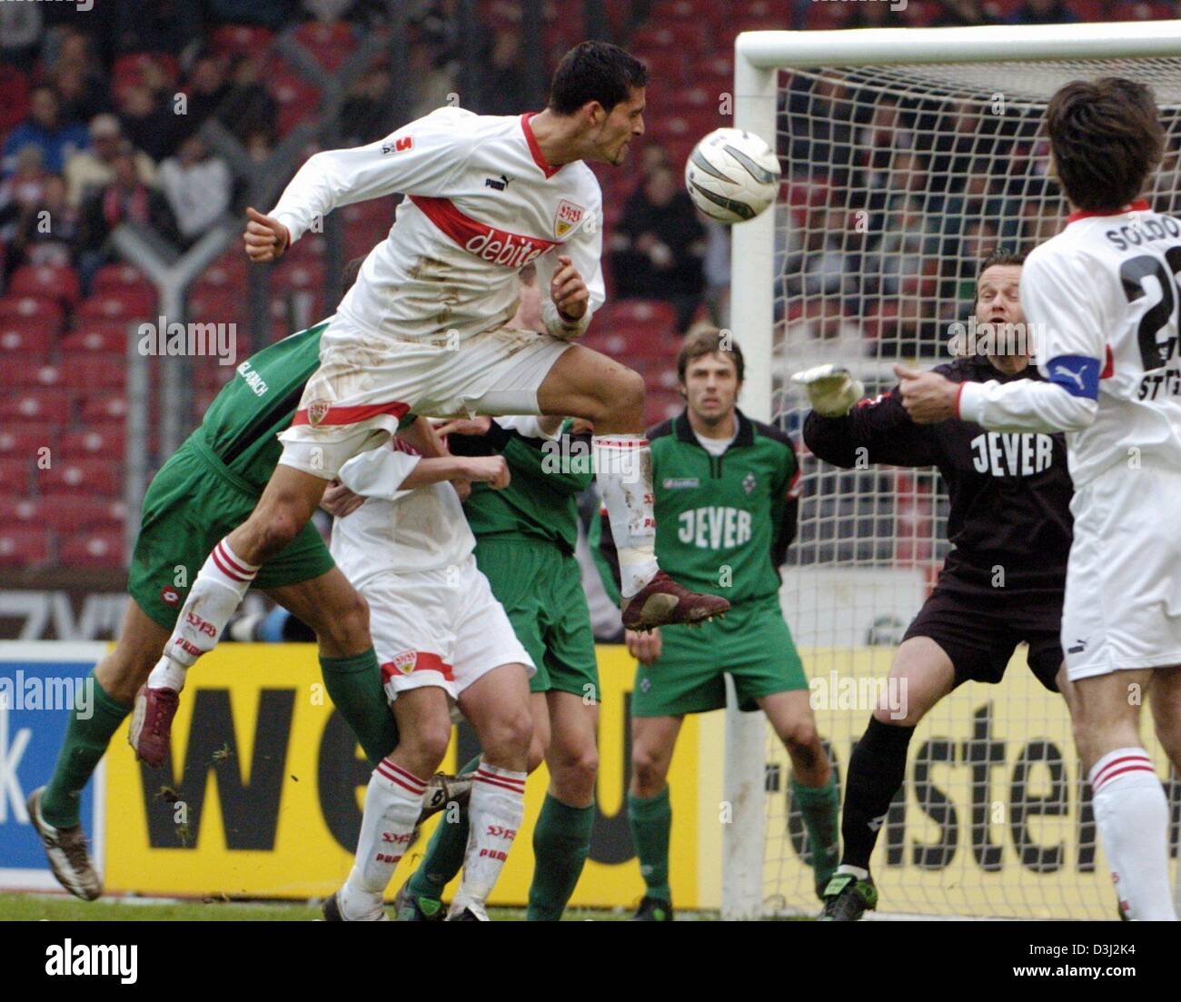 (dpa) VfB Stuttgart forward Kevin Kuranyi (left, in front) jumps high for header against Borussia Moenchengladbach goalie Joerg Stiel (second right in background) and his teammate Zvonimir Soldo (right). The game ended in 1:1 draw on 14 February 2004 at the Daimler Stadion in Stuttgart, Germany. Stock Photo