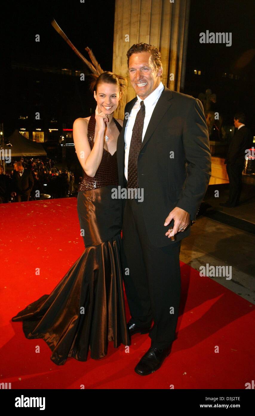 (dpa) - Katrin Wrobel, Miss Germany 2002, and German Hollywood actor Ralph Moeller pose upon their arrival at the 'Cinema for Peace' charity gala in Berlin, 9 February 2004. The proceeds of the gala, which was held on the sidelines of the Berlinale Film Festival, will go to UNICEF and Aids research institutions. Stock Photo
