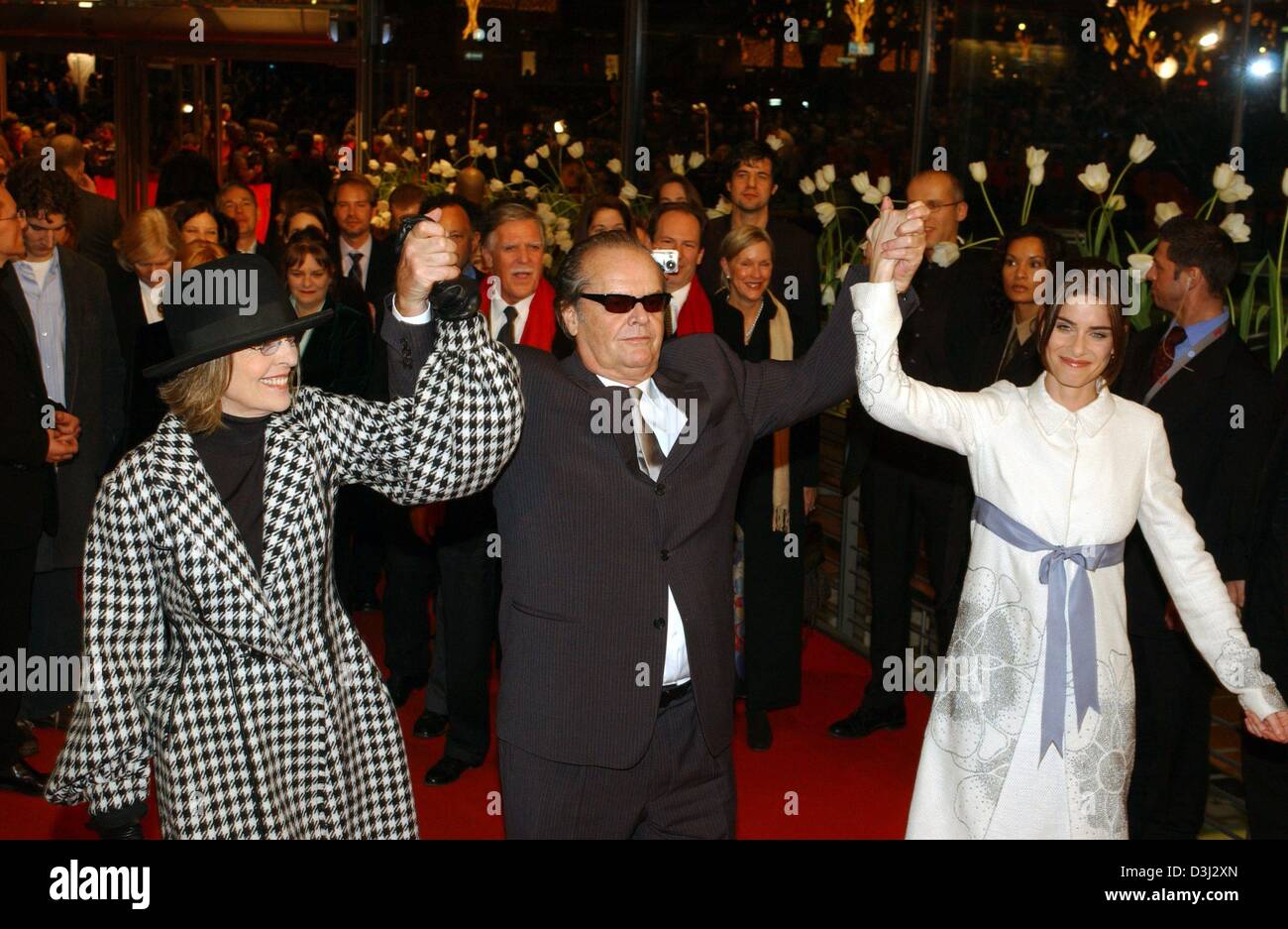 (dpa) - US actresses Diane Keaton (L) and Amanda Peet (R) hold up their arms together with US actor Jack Nicholson on their arrival to the premiere of their  new film 'Something Gotta Give' at the 54th International Film Festival in Berlin, 6 February 2004. The film will participate in the festival's competition and will be released in Germany on 12 February 2004. Stock Photo