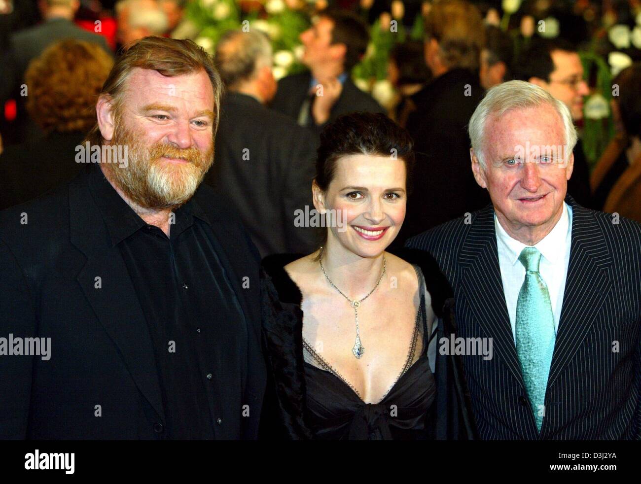 (dpa) - Irish actor Brendan Gleeson (L), French actress Juliette Binoche (C)  and British director John Boorman smile on their arrival to the premiere of their new film 'Country of my Skull' at the 54th Berlinale international film festival in Berlin on Saturday, 07 February 2004. The film deals with the Truth Commission which is concerned with throwing light on crimes committed by Stock Photo