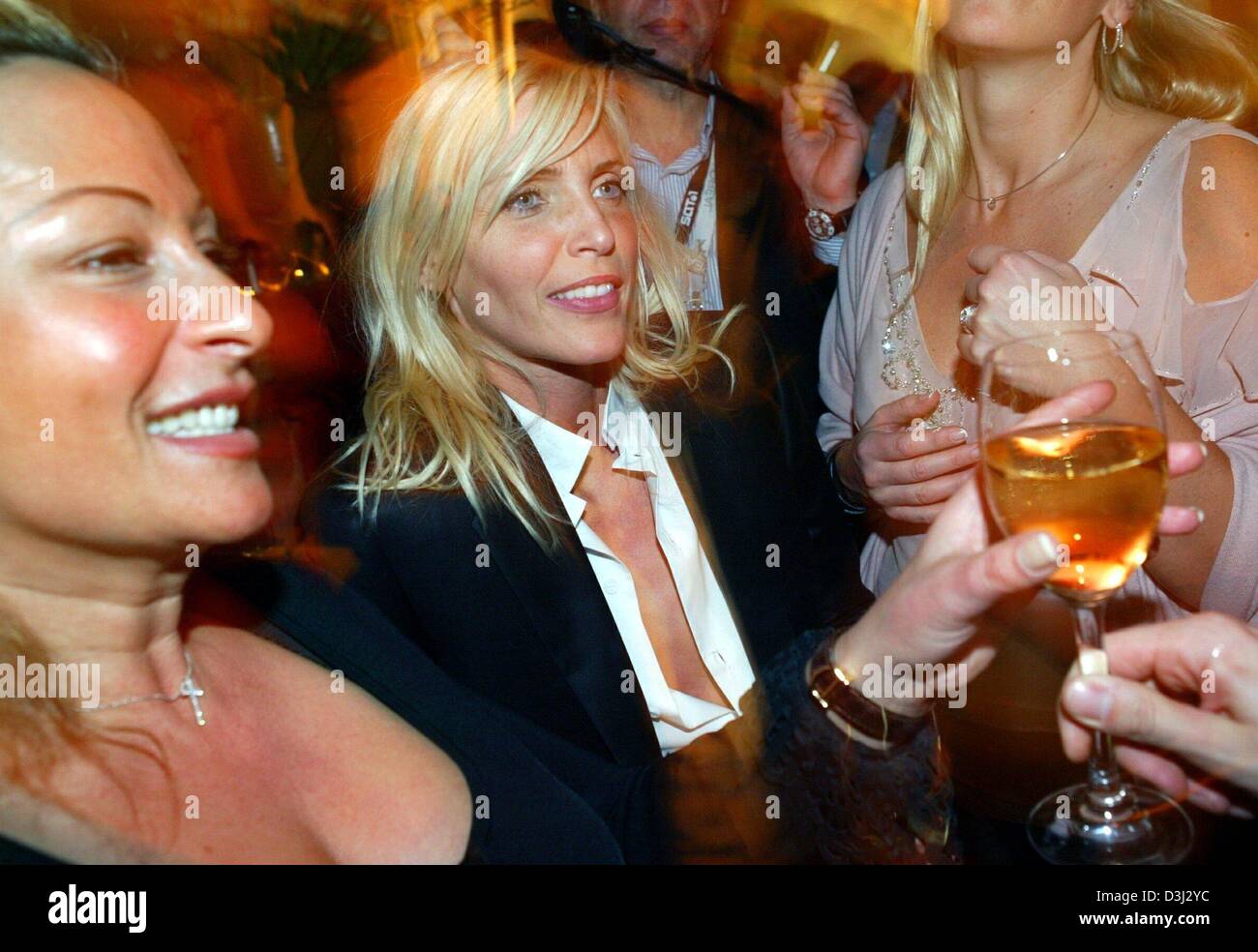 (dpa) - German model Nadja Auermann (L) cheers with a glass of wine as she attends the 'Peoples Night 2004' celebrity party in Berlin, 7 February 2004. The party took place in the conext of the 54th Berlinale Film Festival and was attended by numerous celebrities from culture, economy and politics. Stock Photo
