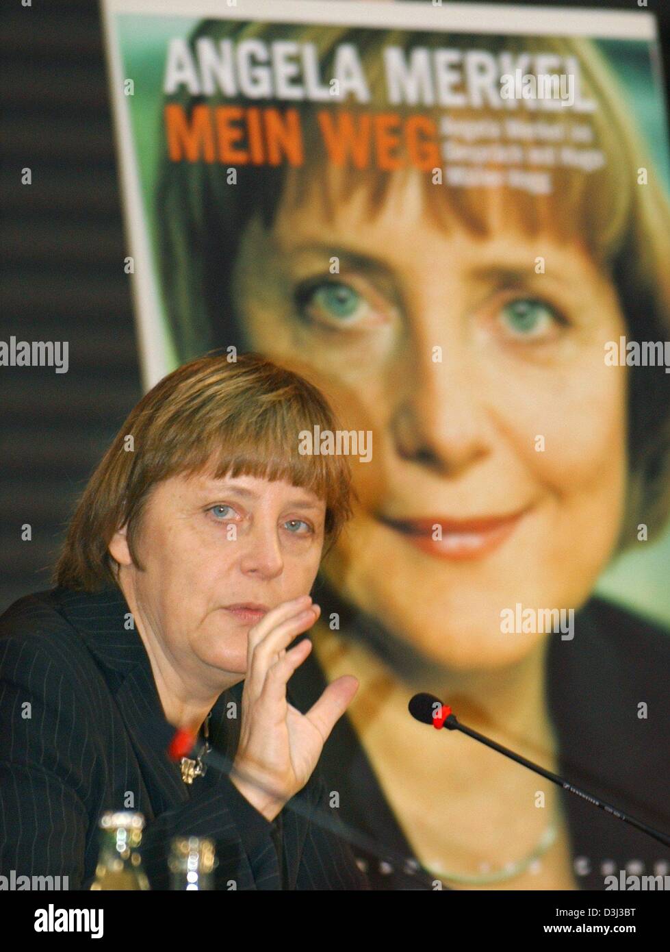 (dpa) - Angela Merkel, Chairwoman of the oppositional CDU party, gestures as she presents her new book during a press conference in Berlin, 12 January 2004. The book entitled 'Mein Weg. Angela Merkel im Gespraech mit Hugo Mueller-Vogg' (my way. Angela Merkel in a dialogue with Hugo Mueller-Vogg) was presented together with publicist Mueller-Vogg. Stock Photo