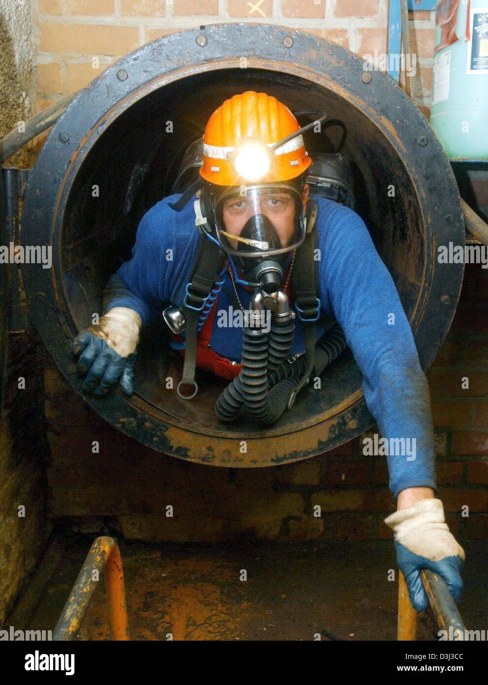 (dpa) - A mine rescue worker emerges from a tunnel during an emergency exercise at the Steinkohle AG pit in Hamm, Germany, 8 September 2003. The rescue workers are the fire brigade of pits and collieries. Stock Photo