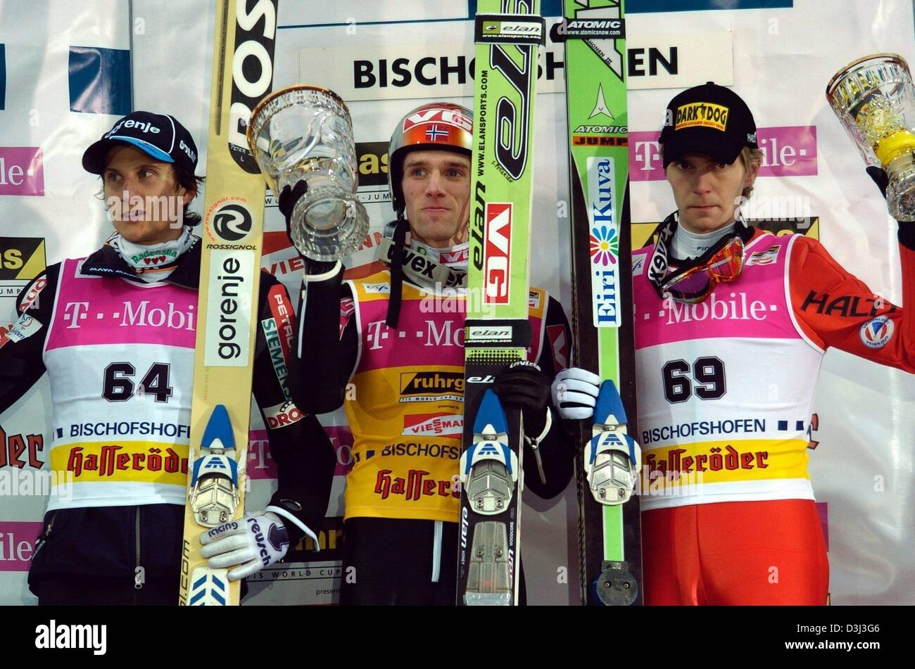 (dpa) - Norwegian ski jumper and overall winner Sigurd Pettersen (C) poses on the podium with second placed Peter Zonta from Slovenia (L) and third placed Janne Ahonen from Finland, after the last stage of the Four Hills tournament in Bischofshofen, Austria, 6 January 2004. Pettersen won the tournament with his third victory of the event, giving Norway their first overall title in  Stock Photo