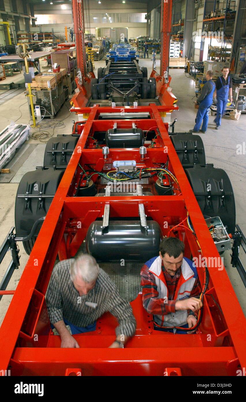 (dpa) - Labourers work on the car bodies of lorries at the vehicles manufacturer Schmitz-Gotha Fahrzeugwerke in Gotha, Germany, 14 November 2003. The Schmitz Cargobull group has been investing in its subsidiary in Gotha since 1997. About 420 employees produce about 3,850 dump trucks and container vehicles per year. Stock Photo