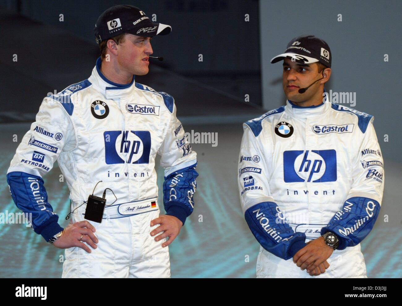 (dpa) - German formula one pilot Ralf Schumacher (L) and his Colombian team mate Juan Pablo Montoya pictured during the presentation of the new BMW-Williams FW26 racing car for the upcoming season, in Valencia, Spain, 5 January 2004. The car has a new aerodynamic concept and a new motor. The FW26 will be intensively tested in Jerez, Spain, as of 7 January 2004. Stock Photo